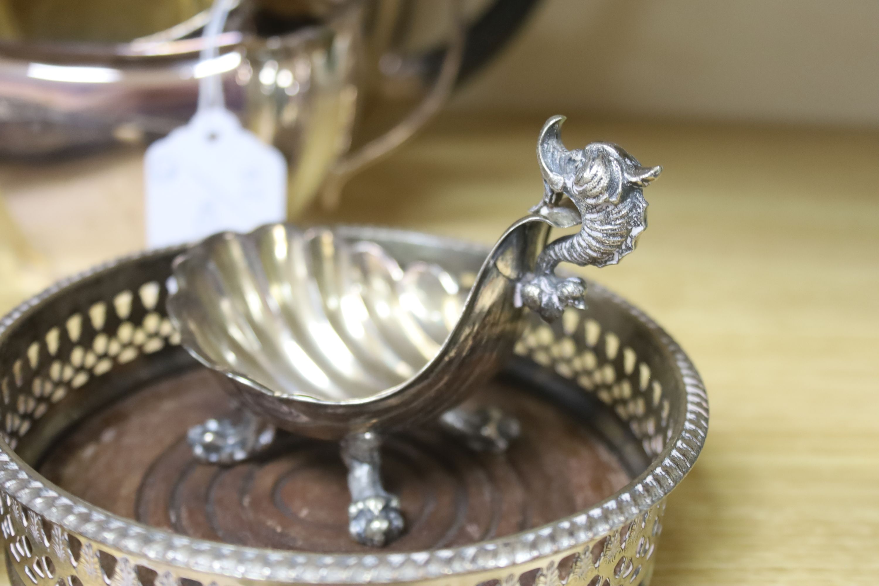 A three piece plated teaset, a pair of coasters and a shell salt